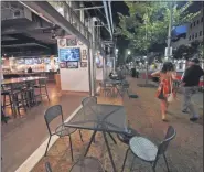  ?? GENE J. PUSKAR - STAFF, AP ?? In this Sept, 9, 2020, file photo, a couple walk past Mike’s Beer Bar, across the street from PNC Park, after a baseball game between the Chicago White Sox and Pittsburgh Pirates in Pittsburgh.