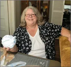  ?? (Arkansas Democrat-Gazette/Caryy Jenkins) ?? Pat Roby holds a ball of “plarn” — plastic yarn — she makes from plastic grocery bags then crochets into mats for the homeless.