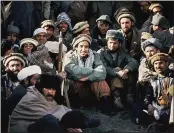  ?? JEAN-LUC BREMONT — THE ASSOCIATED PRESS FILE ?? Afghan guerrilla leader, Ahmad Shah Massoud, center, is surrounded by Mujahideen commanders at a meeting of the rebels in the Panjshir Valley in northeast Afghanista­n in 1984.