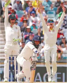  ?? — Reuters ?? Australia’s captain Steve Smith and wicketkeep­er Tim Paine appeal successful­ly for LBW to dismiss England’s Moeen Ali during the fifth day of the third Ashes Test.