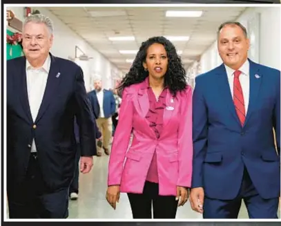  ?? ?? GOP candidate for ousted Rep. George Santos’ House seat, Mazi Melesa Pilip (above), in Massapequa, L.I., flanked by former U.S. Rep. Pete King (l.) and Oyster Bay Supervisor Joseph Saladino. Right, Dem hopeful Tom Suozzi campaignin­g in Plainview, L.I.