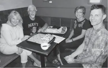  ?? CITIZEN PHOTO BY CHRISTINE HINZMANN ?? Valerie Rakoczy, John Aitken, Suzanne LeFebvre and Reace Rakoczy get ready to play Scrabble on Scrabble Sunday at Books &amp; Co. on Sunday.