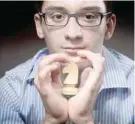  ??  ?? US chess champion Fabiano Luigi Caruana poses with his favourite chess piece (a knight). — AFP