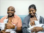  ?? ALLEN JONES/COURTESY OF VCU MEDICAL CENTER ?? Adeboye and Ajibola Taiwo hold two of their sextuplets who were born May 11 at VCU Medical Center.