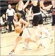  ?? Westside Eagle Observer/MIKE ECKELS ?? Shylee Morrison (left) screams past a pair of Lady Blackhawk defenders on her way to the net for a layup during the fourth quarter.