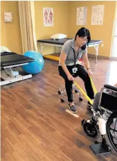  ??  ?? Physical therapy aide Jessica Harrison helps a resident with a stretching exercise at The Neighborho­od, which calls itself a “life care community. “