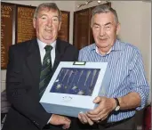  ??  ?? Len O’Connell who finished third in the Baltinglas­s golf Club Captain’s Prize receives his rewward from club captain John Kelly.