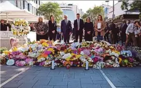  ?? AFP PIC ?? Australian Prime Minister Anthony Albanese (third from left) and New South Wales Premier Chris Minns (third from right) paying tribute to knife attack victims at the Westfield Bondi Junction mall in Sydney yesterday.