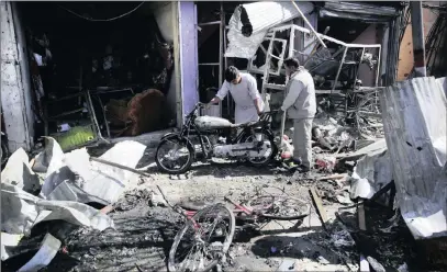  ?? PICTURE: AP ?? Residents inspect the damage at the site of a suicide attack in Kabul, Afghanista­n, yesterday.