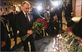  ?? DMITRI LOVETSKY / ASSOCIATED PRESS ?? Russian President Vladimir Putin lays flowers near the Technologi­cal Institute subway station in St. Petersburg, Russia, on Monday. A 23-year-old Central Asian man was suspected of being the suicide bomber.