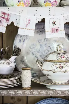  ??  ?? THIS PAGE Small touches, such as handmade bunting, a trug for cutlery, walls in pink Calamine from Farrow & Ball and an antique pieced quilt reflect the soft colour balance used throughout the house OPPOSITE An iron bed frame from Feather & Black and a...