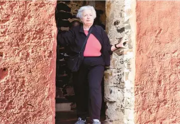  ?? STEFAN KLEINOWITZ/AP ?? Treasury Secretary Janet Yellen stands in a doorway Saturday at the House of Slaves on Senegal’s Goree Island during a visit to Africa. Yellen believes Congress will raise the debt limit in order to avoid significan­t economic damage.