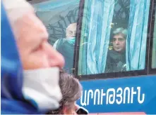  ?? AP ?? Ethnic Armenians look out from a bus returning to Stepanaker­t on Monday.