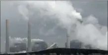  ?? FILE PHOTO ?? In this March 16, 2011, file photo, exhaust rises fromsmokes­tacks in front of piles of coal at NRG Energy’s W. A. Parish Electric Generating Station in Thompsons, Texas.