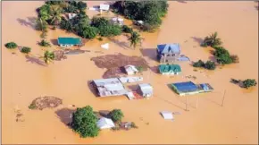  ?? PHILIPPINE COAST GUARD/AFP ?? Houses are submerged in the Philippine­s’ Cagayan province, north of Manila, on Saturday, days after Typhoon Vamco hit parts of the country.