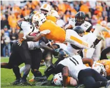  ?? STAFF FILE PHOTO BY ERIN O. SMITH ?? Tennessee running back John Kelly dives into the end zone for a touchdown during the Vols’ home game against Vanderbilt in November.