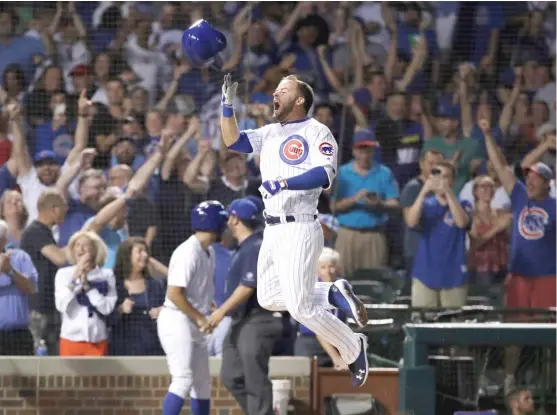  ?? NAM Y. HUH/AP ?? Pinch hitter David Bote throws off his helmet as he rounds the bases after hitting the game-winning grand slam Sunday night against the Washington Nationals.