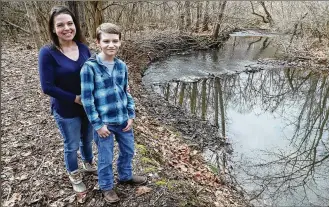 ?? BILL LACKEY / STAFF ?? Keli Henley and her son, Jack, spend a lot of time by the stream in their back yard. Jack is immunocomp­romised, and so, because of COVID-19, they don’t go out in public. “He loves to fish,” says Jack’s mother, “but besides that the whole thing has been extremely isolating.”