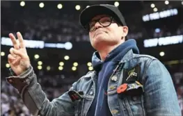  ?? FRANK GUNN, THE CANADIAN PRESS ?? The Tragically Hip lead singer Gord Downie salutes fans during a Toronto Raptors playoff game earlier this year. Gord Downie and indigenous activist Sylvia Maracle will be appointed to the Order of Canada on Monday. Maracle will be named an officer of...