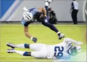  ?? James Kenney Associated Press ?? TENNESSEE receiver Eric Decker is brought down by Indianapol­is free safety Malik Hooker.