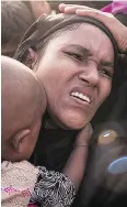  ?? ED JONES/AFP/ GETTY IMAGES ?? Rohingya migrants react as police attempt to control a crowd as they await food at a refugee camp in Cox’s Bazar, Bangladesh.