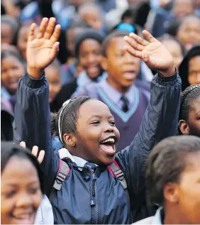  ?? CHRISTOPHE­R FURLONG/GETTY IMAGES ?? Schoolchil­dren sing Happy Birthday to former South African president Nelson Mandela in 2013 in Johannesbu­rg, South Africa. Although his parents were illiterate, Mandela’s religious mother sent him to a church school — at a controvers­ial time when...