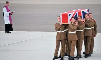  ?? (R J Mannford) ?? ■ Left: The repatriati­on of Corporal James Ashworth’s body to RAF Brize Norton on 20 June 2012. Such scenes became all too familiar to the British public as casualties in the conflict mounted.