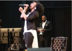  ??  ?? Pastor Jesse Curney III of the New Mercies Christian Church in Lilburn, Ga., watches Praise and Worship singer April Thompson perform during the Aug. 2 church service. (Steve Schaefer for the Atlanta Journal-Constituti­on)