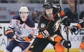  ?? Sean M. Haffey Getty Images ?? RYAN GETZLAF skates past Ryan Nugent-Hopkins of the Oilers in Game 3 of their playoff series. Getzlaf says the Ducks are learning to stay calm under fire.