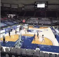  ?? David Butler II / Associated Press ?? The UConn Huskies take on the Xavier Musketeers to an almost empty Harry A. Gampel Pavilion in Storrs on Dec. 19. UConn defeated Xavier 106-59. The UConn athletic budget deficit increased to $43.5 million.