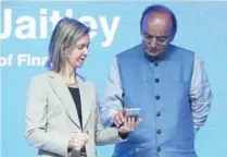  ?? AFP ?? Vice-president and head of finance and commerce products on Google’s Next Billion Users team Diana Layfield (L), and Finance Minister of India Arun Jaitley look at a mobile during the launch of the Google ‘Tez’ mobile app for digital payments in New...