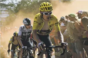  ?? AFP ?? Team Sky’s Geraint Thomas beat his leader Chris Froome, in white and black, to lead the Tour de France after Stage 12
