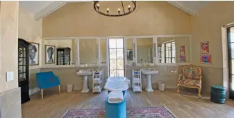  ?? ?? ABOVE: Large and glamorous bathrooms are found at all Royal Portfolio hotels. This one is at The Farmstead at Royal Malewane in the Greater Kruger.