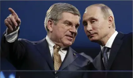  ?? ASSOCIATED PRESS FILE PHOTO ?? IOC President Thomas Bach, left, and Russian President Vladimir Putin watch the closing ceremony of the 2014 Winter Olympics in Sochi, Russia.