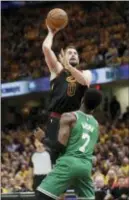  ?? TONY DEJAK — THE ASSOCIATED PRESS ?? Cleveland’s Kevin Love shoots over Boston’s Jaylen Brown in the first half of Game 3 of the Eastern Conference finals Saturday.