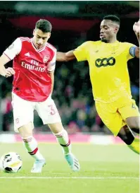  ??  ?? Arsenal’s Gabriel Martinelli (left) competes for the ball with Standard Liege’s Dimitri Lavalee during a Europa League Group F match yesterday.