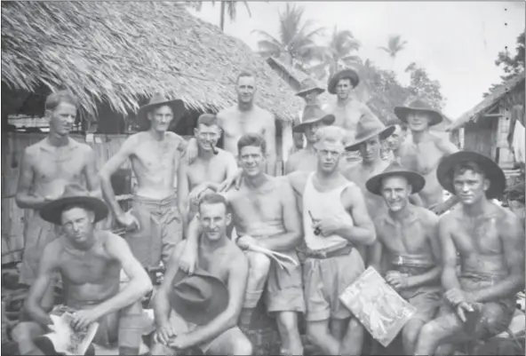  ?? PHOTO: AWM ?? Survivor! Informal group portrait of A Company 2/18th Battalion in front of huts in Malaya in 1941. Local Dubbo boy Pte Carl George Von Schill is second row, second from left. He survived being a POW of the Japanese. Almost all the young men in the photo, however, either died in combat, as prisoners, or survived the war as POW’S of the Japanese following the surrender of Singapore in February 1942.