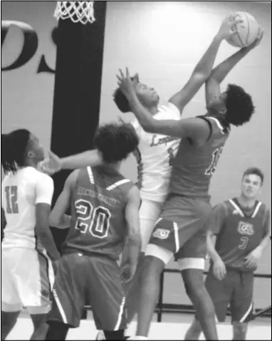  ?? Photos by Gerren Smith ?? Top right: Malvern’s Kealon Juniel times a perfect block against Arkadelphi­a’s Courtlon Crow for a big man battle.