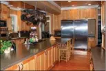  ??  ?? The gourmet kitchen is fully equipped with top-ofthe-line stainless-steel appliances.