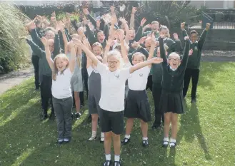  ??  ?? Grange Park Primary School pupils celebrate after winning bikes from Halfords.