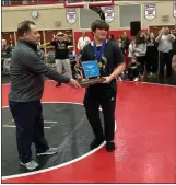  ?? BRIAN RIPPEY — SPECIAL TO THE READING EAGLE ?? Berks Catholic captain Brody Kline looks at his teammates after accepting the District 3Class 2A team champion trophy from Steve Navaroli, District 3 director of communicat­ions.