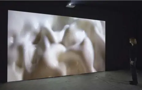  ??  ?? Luis Jacob’s Without Persons consists of two huge screens, each filled with a milky-white paste that produces indistinct, glistening biomorphic forms.