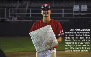  ?? NEWS PHOTO JAMES TUBB ?? Medicine Hat Mavericks centre fielder Braden DeSonia holds up the base from Athletic Park on which he registered his WCBL recordsett­ing 41st stolen base during Friday night’s 10-4 win over the Weyburn Beavers.