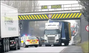  ??  ?? A lorry wedged beneath the railway bridge across the A5 in Hinckley