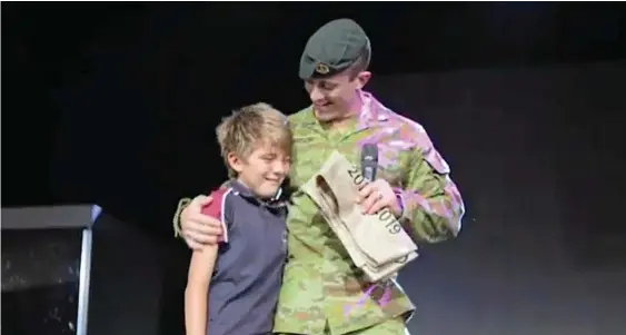  ?? Photo: Contribute­d ?? SPECIAL MOMENT: William Anderson is reunited with his father Lieutenant Michael Anderson at a Highlands Christian College school assembly.