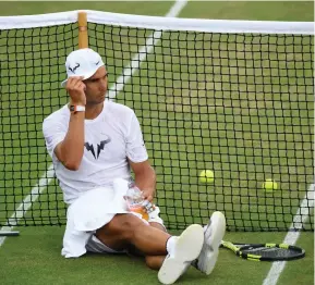  ?? REUTERS ?? JUICE BREAK: Spain’s Rafael Nadal rests during a practice session at Wimbledon yesterday.
