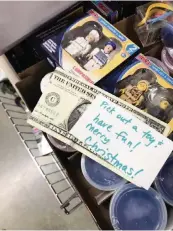  ?? DEBBIE MCFARLAND via AP ?? Debbie McFarland left a dollar bill and an encouragin­g note in a bin of toys at a store in Peachtree City, Georgia.