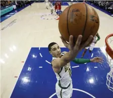  ?? ASSOCIATED PRESS ?? EASY STREET: Jayson Tatum lays in two of his 20 points in the Celtics’ 112-109 win against the 76ers last night in Philadelph­ia.