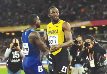  ?? Associated Press ?? n United States' Justin Gatlin, left, shakes hands with Jamaica's Usain Bolt after winning the Men's 100-meter final during the World Athletics Championsh­ips on Saturday in London.