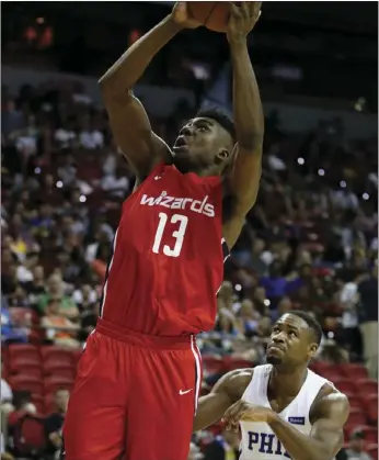  ??  ?? Washington Wizards’ Thomas Bryant shoots over Philadelph­ia 76ers’ Demetrius Jackson during the second half of an NBA summer league basketball game Monday in Las Vegas. AP PHOTO/JOHN LOCHER